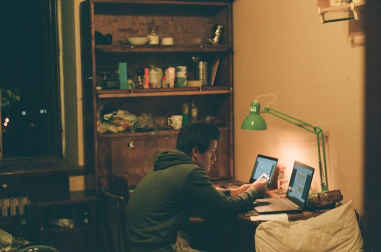 man in black jacket using laptop computer