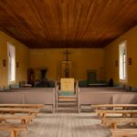 a church with wooden pews and stained glass windows