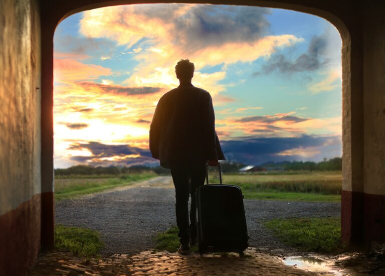 man holding luggage photo, leaving self behind