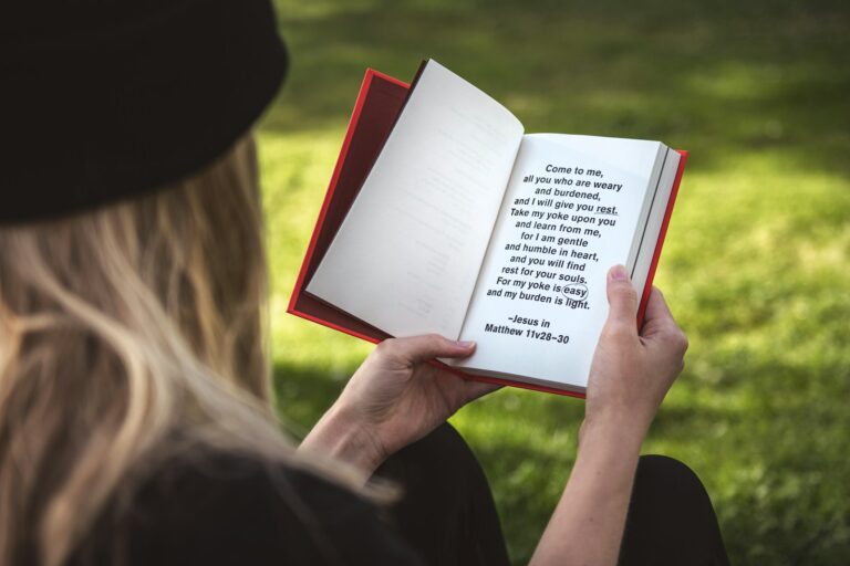 woman holding white and red book