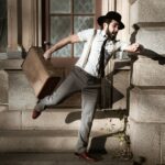 man in white dress shirt and gray pants sitting on gray concrete stairs, time lag, delay