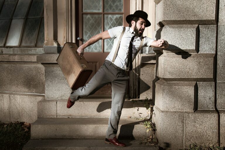 man in white dress shirt and gray pants sitting on gray concrete stairs, time lag, delay