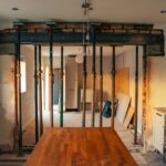 a kitchen with a wooden table in the middle of it