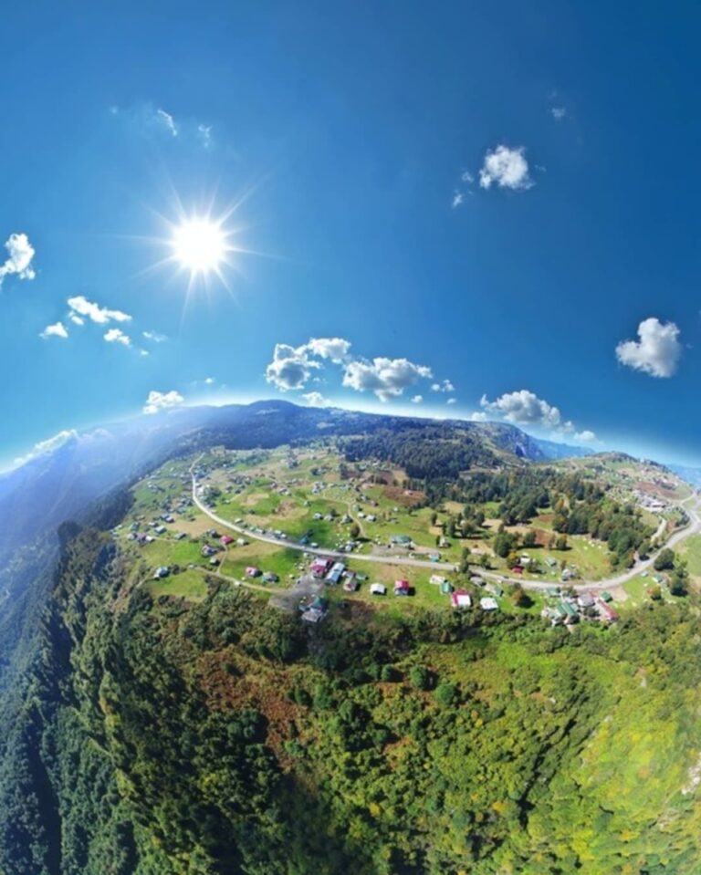 an aerial view of a small town on a hill