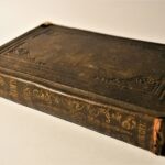 an old book sitting on top of a white table